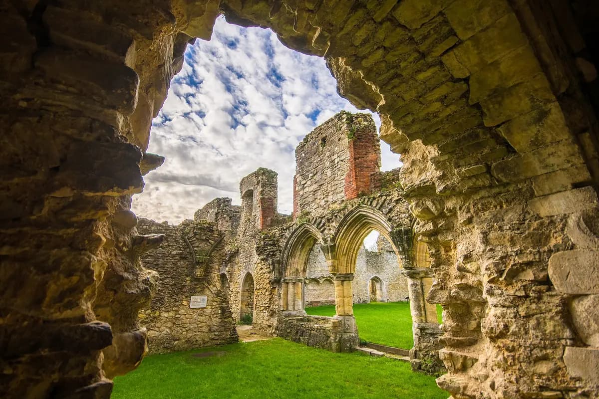 Looking through a stone arch at the ruins of Netley Abbey